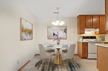 a kitchen and dining room with a table and chairs