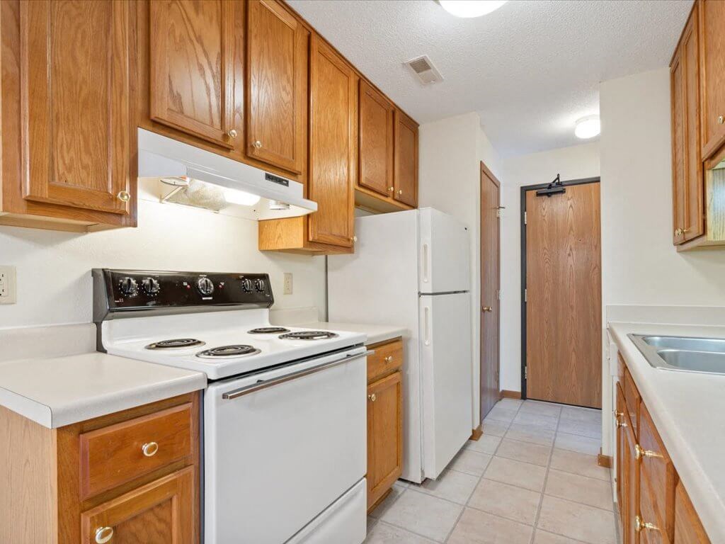 a kitchen with white appliances