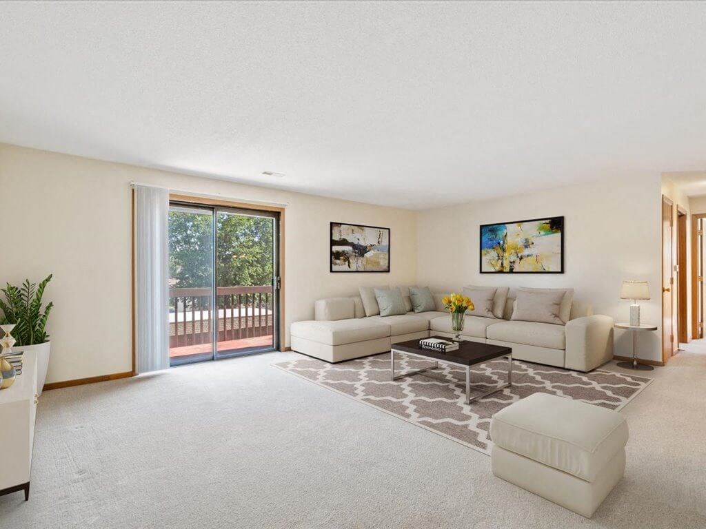 living room with a sliding glass door to balcony