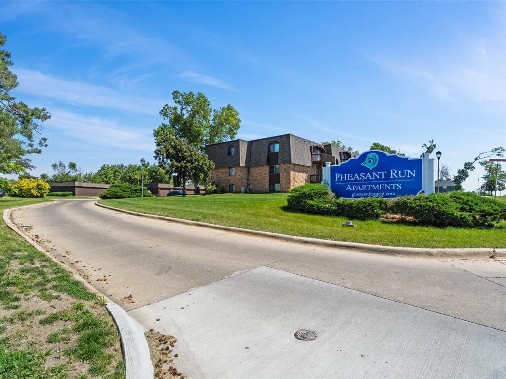 the sign for Pheasant Run apartments