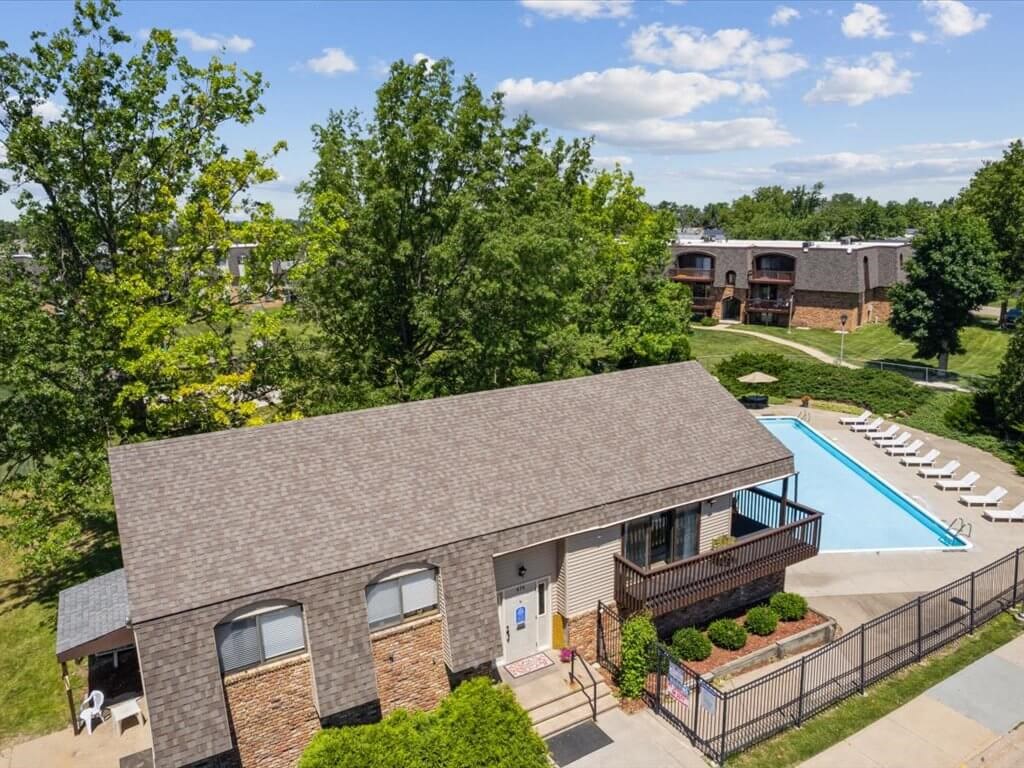 an aerial view of a clubhouse with a pool