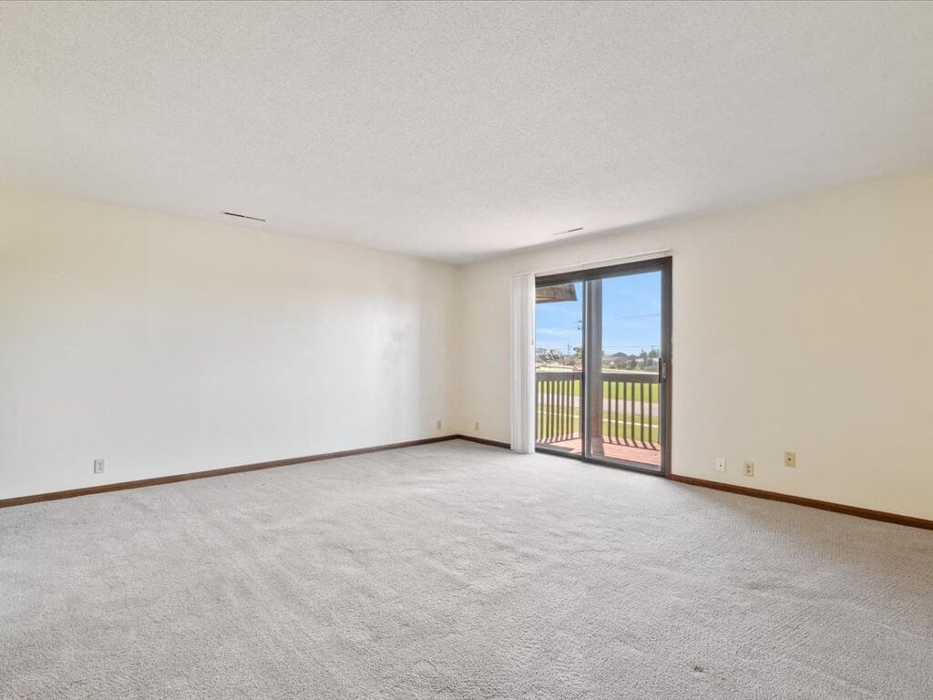 apartment living room with a sliding door to a balcony