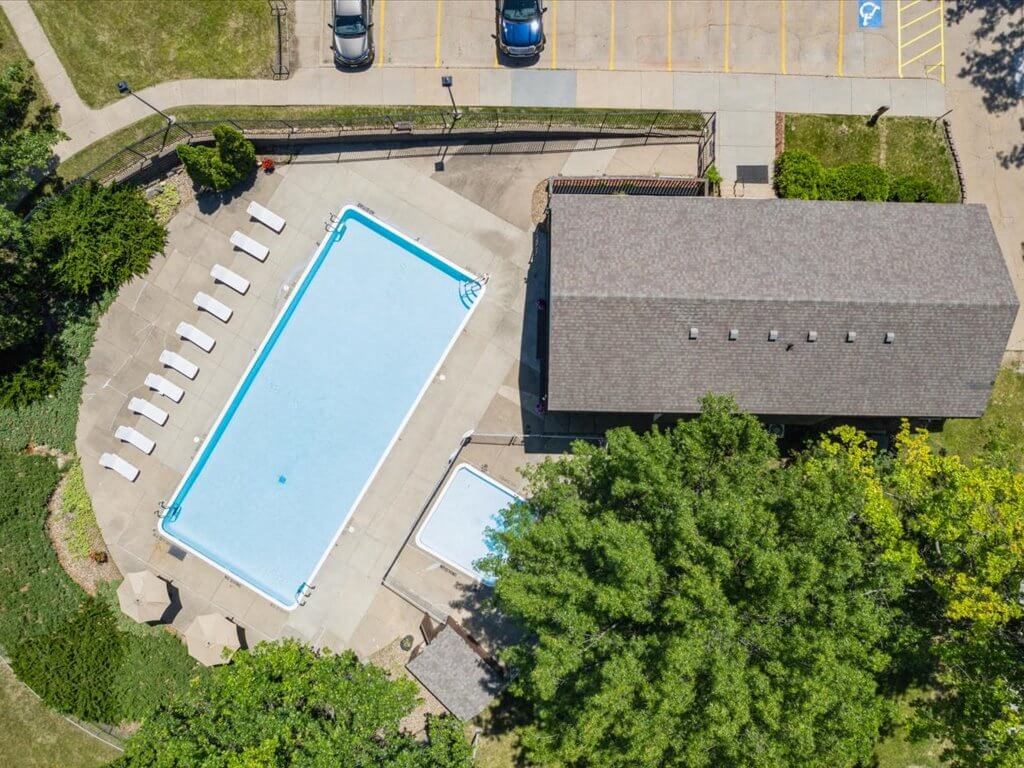 an aerial view of a swimming pool and clubhouse