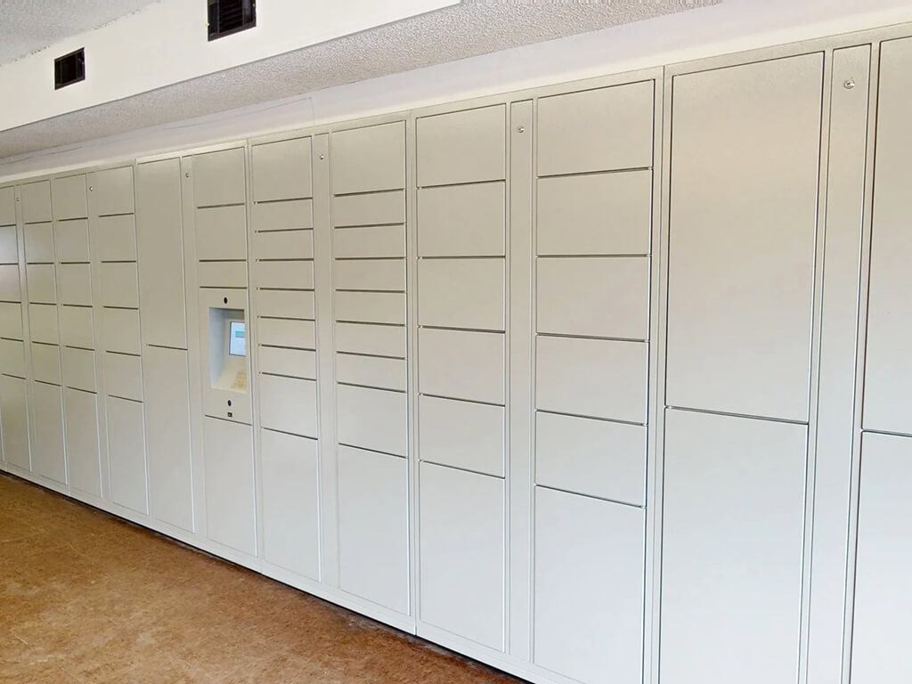 A row of white lockers in a room.