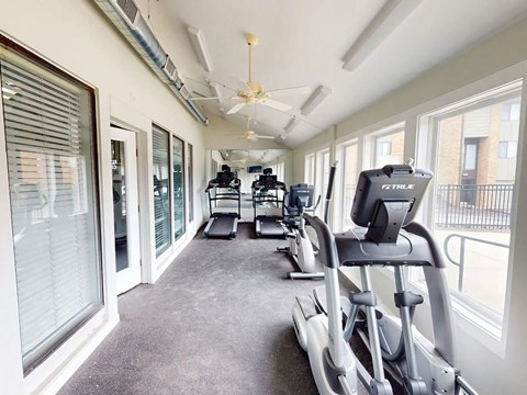 A gym with treadmills and elliptical machines.