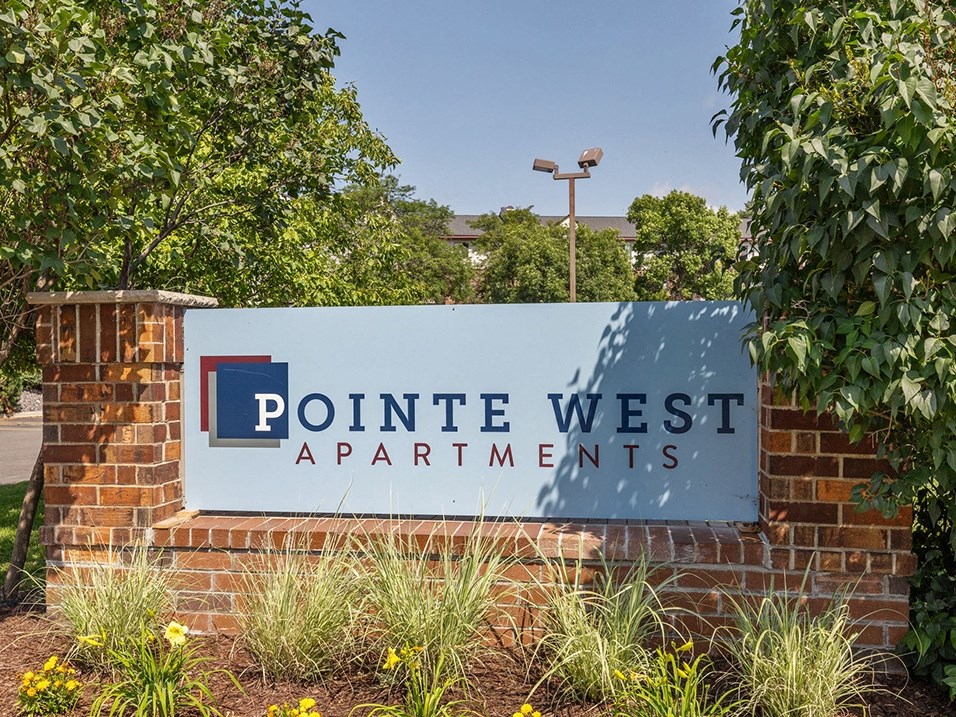 a sign at the entrance of pointe west apartments