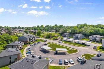 an aerial view of a neighborhood with cars parked in a parking lot