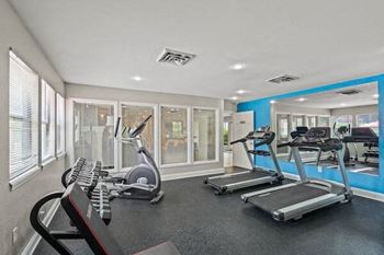 a gym with a bunch of exercise equipment in it