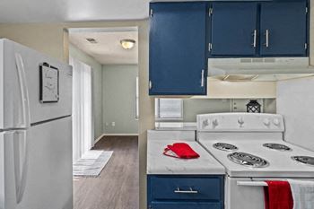 a kitchen with a white stove and a refrigerator
