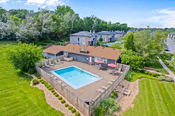 an aerial view of a backyard with a swimming pool