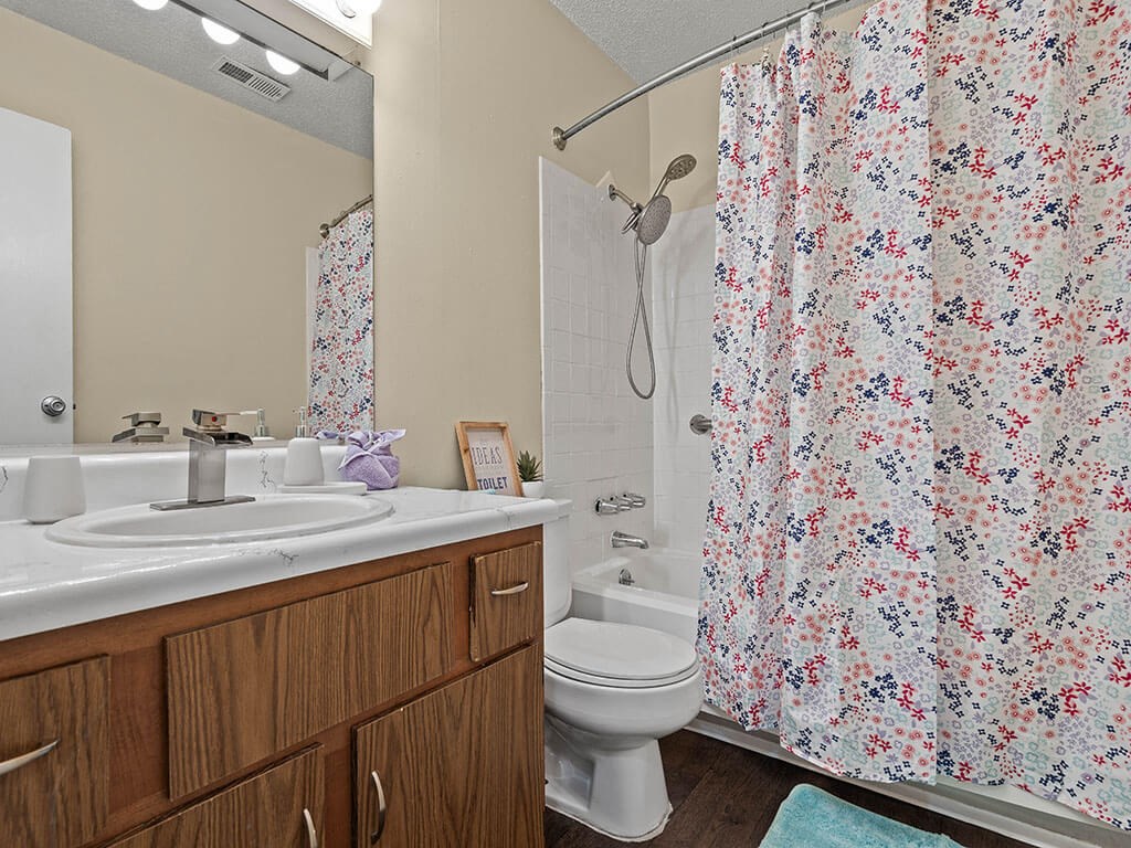 bathroom with a shower tub, sink, and toilet