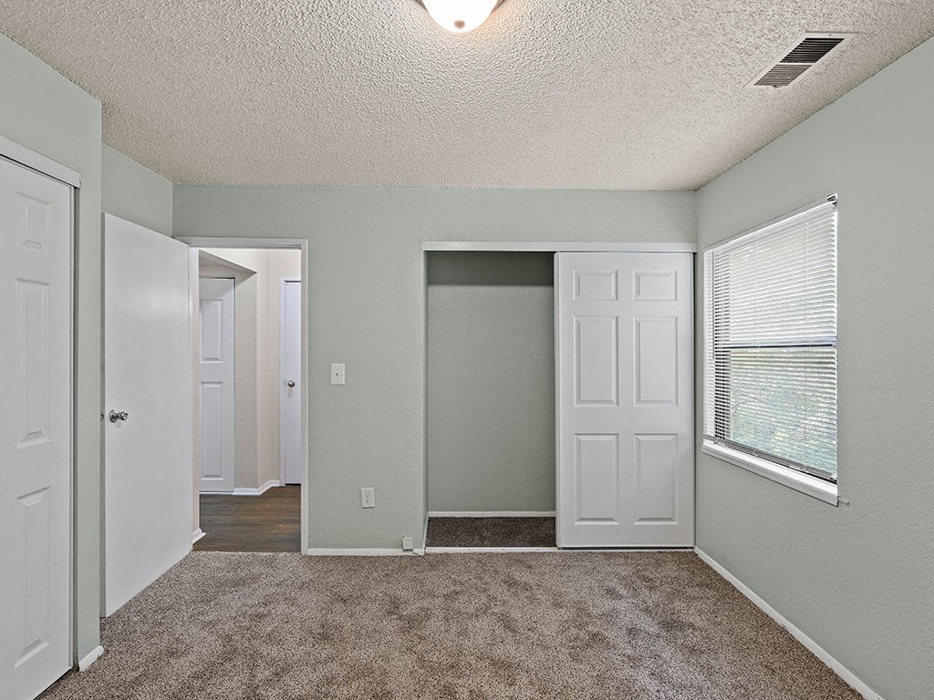 bedroom with a closet and a window