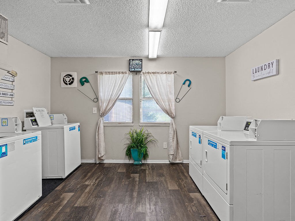 a laundry room with washes and dryers
