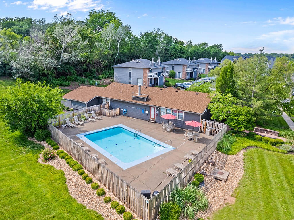 an aerial view of a swimming pool in a backyard