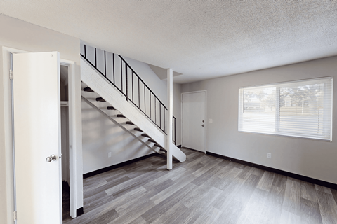 A room with a staircase and a window.
