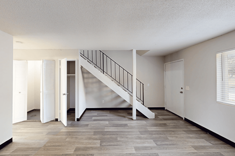 A room with a staircase and a window.