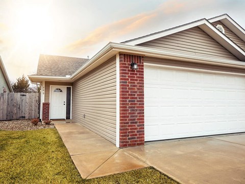 a home with a white garage door and a driveway