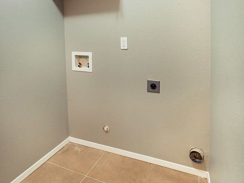 a empty room with two outlets on the wall