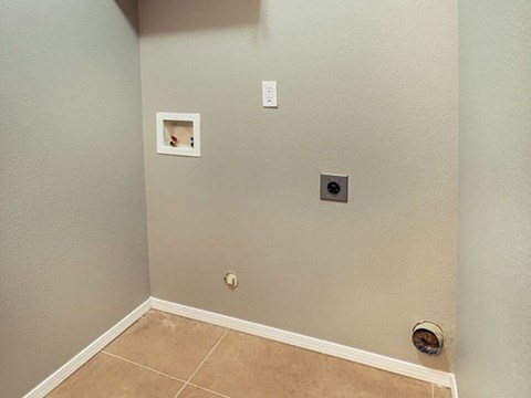 a empty room with two outlets on the wall