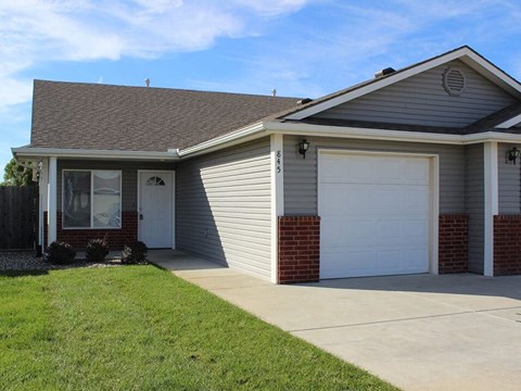 a white house with a driveway and a garage door