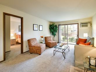 living room with connected bedroom at river's edge apartments