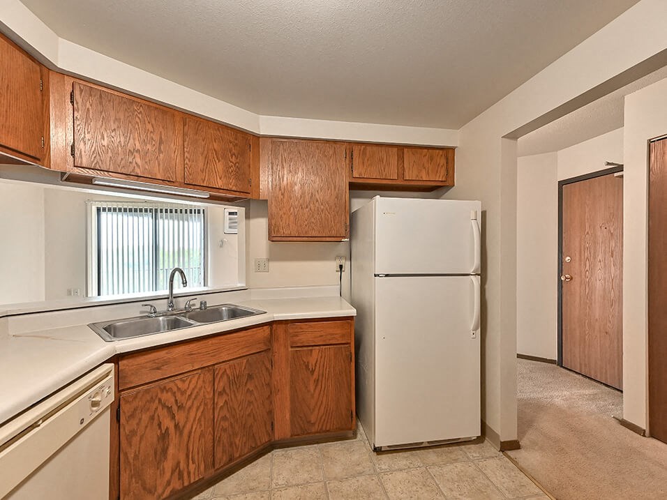 kitchen with wood style cabinets and double sink