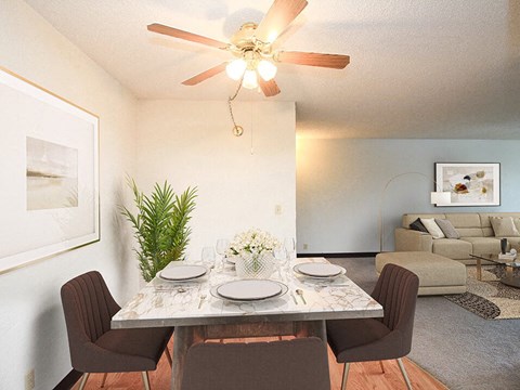 a dining room with a table and chairs and a ceiling fan