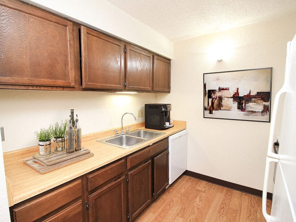 a kitchen with wooden cabinets and a sink
