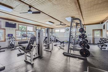 the gym has a lot of equipment in it