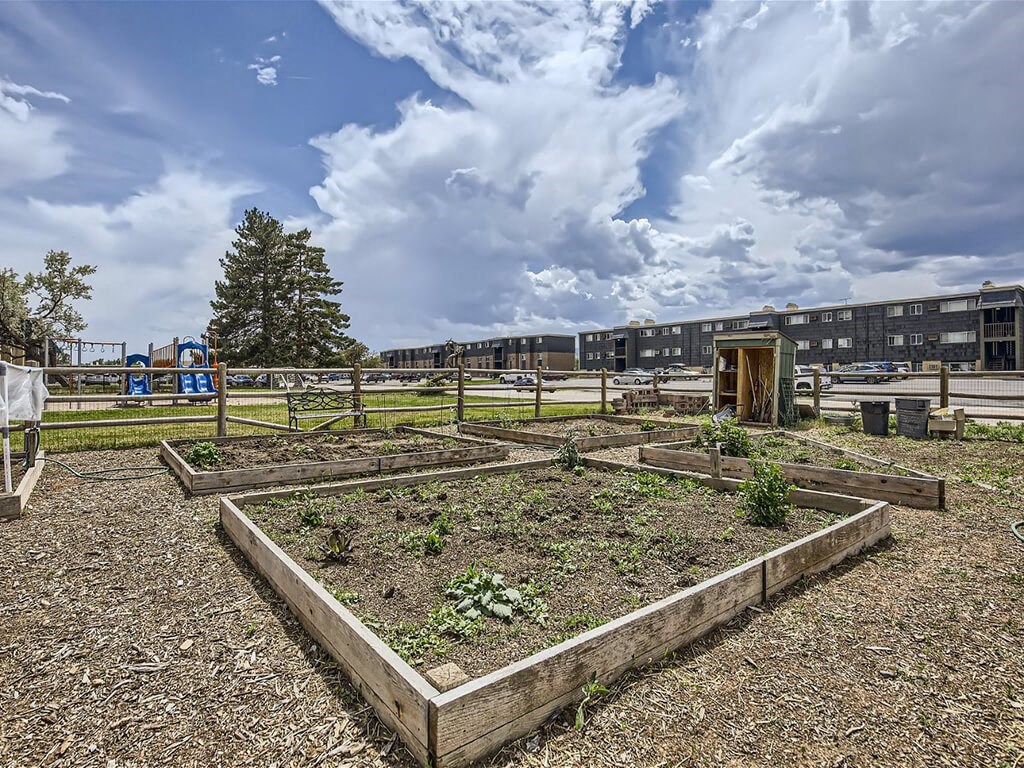 community garden with beds of plants at apartment building