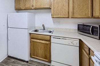 a kitchen with a sink microwave and refrigerator