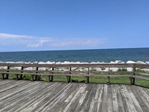 A wooden deck overlooks a body of water.