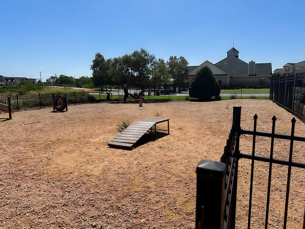 a park bench in the middle of a dirt field