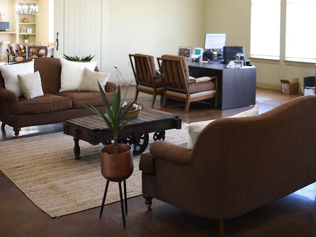 a living room with couches chairs and a table