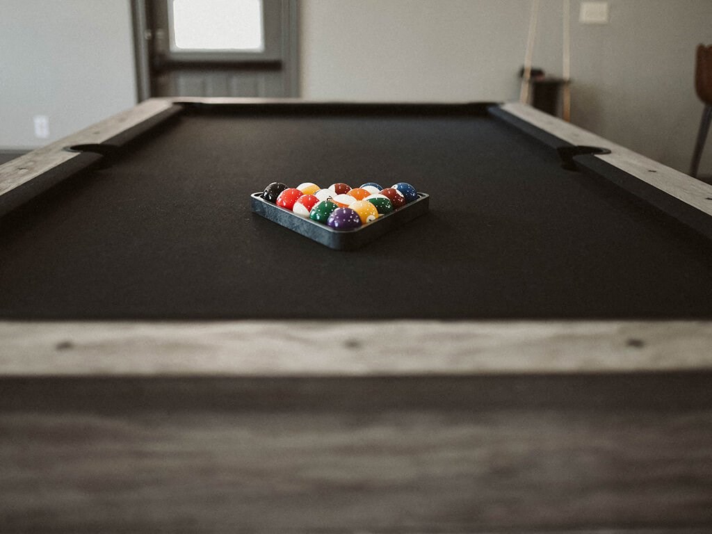 a pool table with a bowl of balls on it