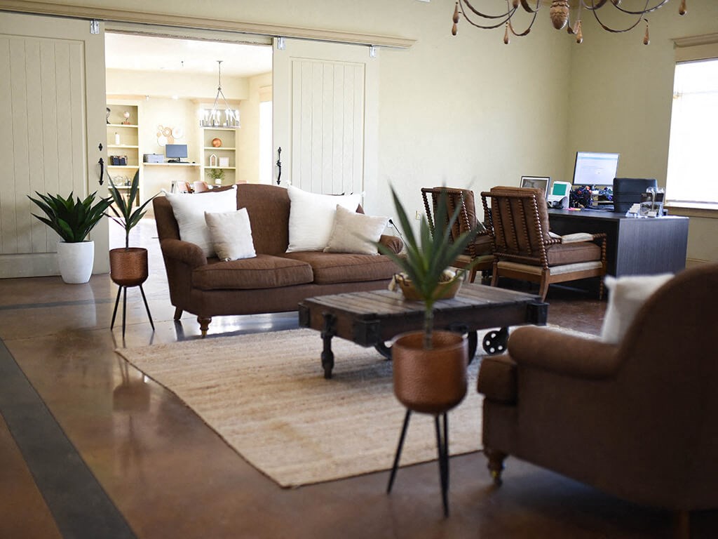 a living room with couches and chairs and a rug