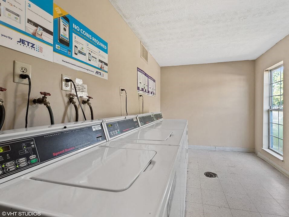 a laundry room at apartment building