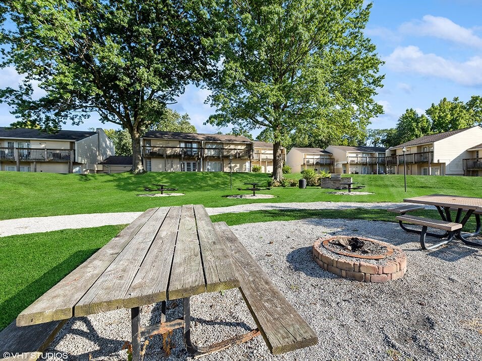 a picnic area with a picnic table and a fire pit