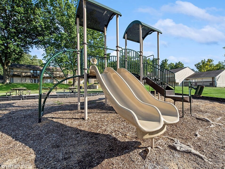 a playground with a slide and a climbing frame