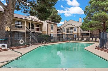 a swimming pool with apartments in the background at saddlecreek