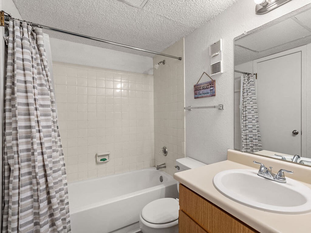 a bathroom with a sink and a shower and a toilet