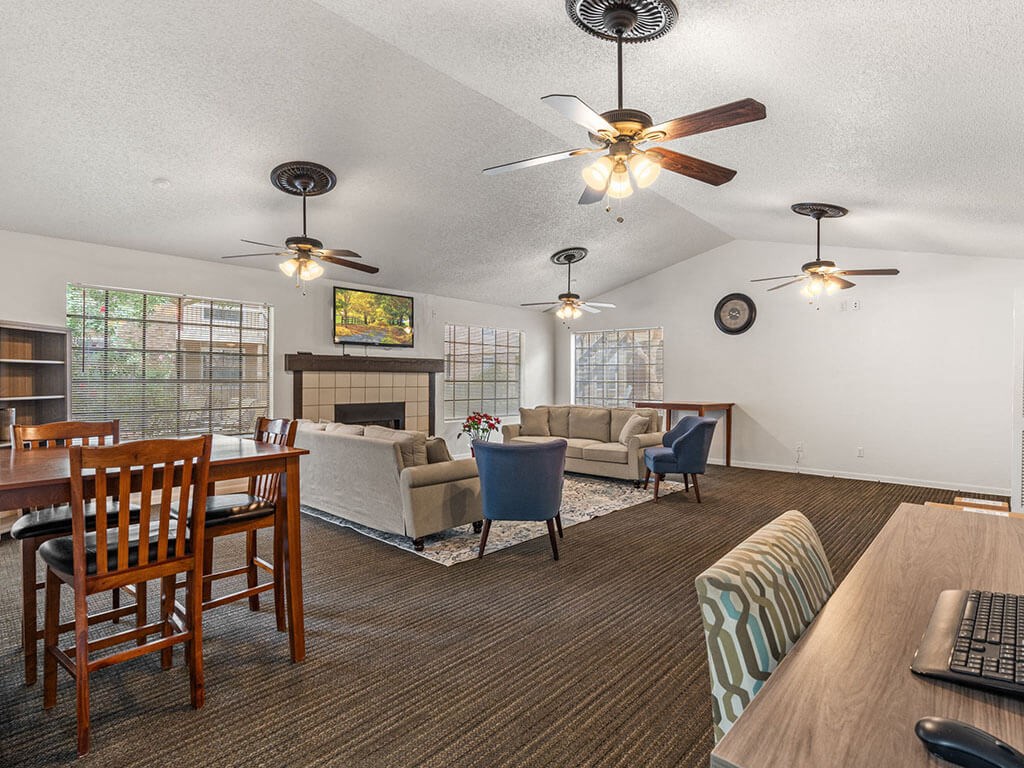 a living room and dining room with couches and a table