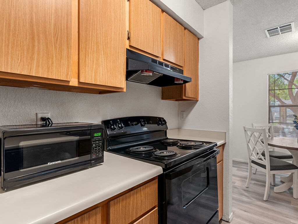 a kitchen with a stove and a microwave