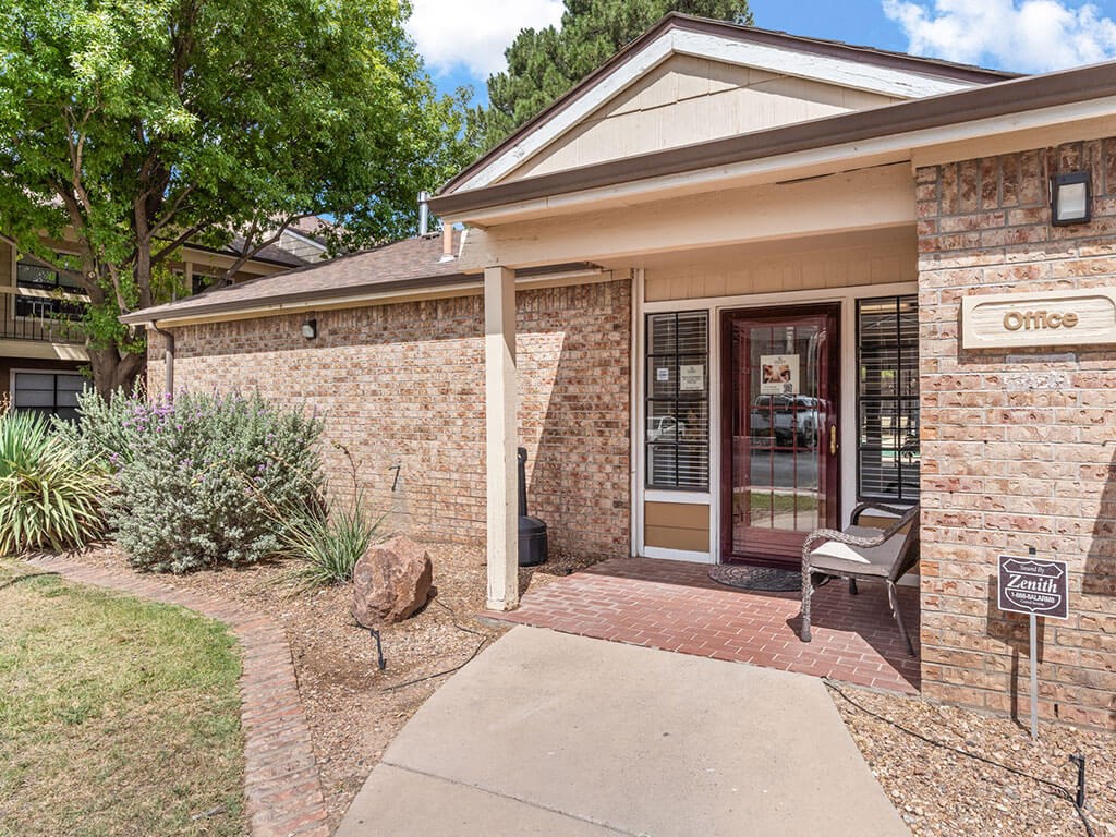 the front entrance of a brick office building