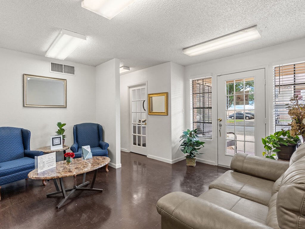 a living room with couches and chairs and a table
