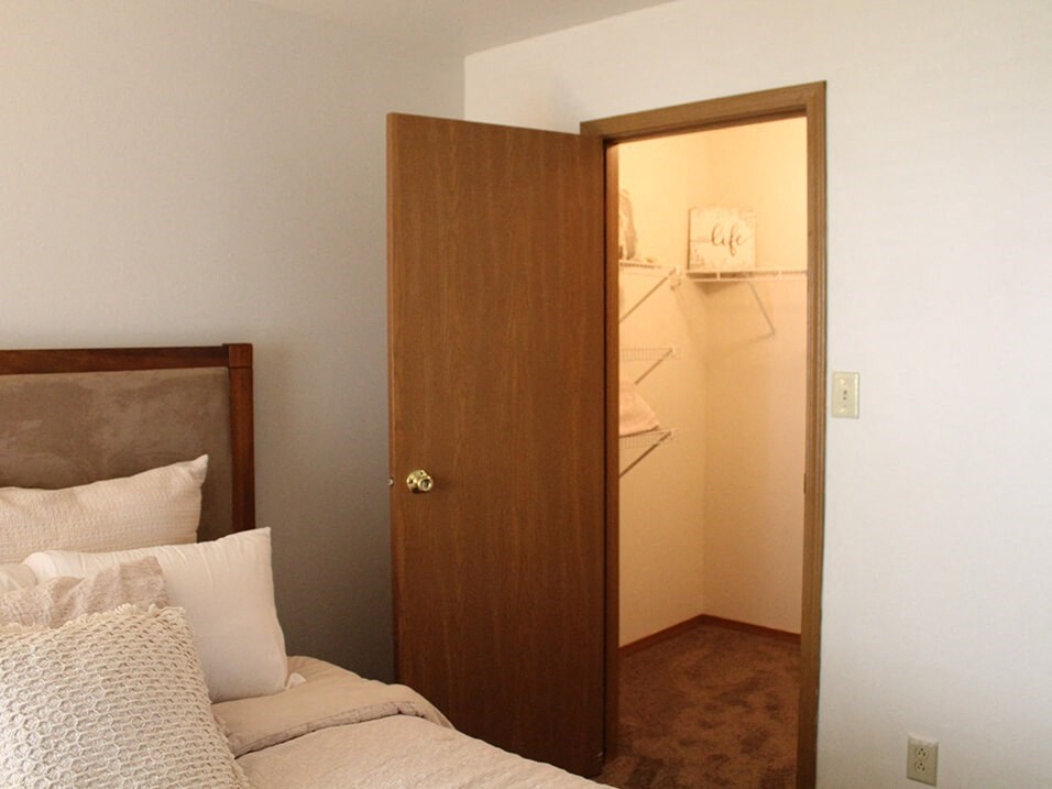 a bedroom with a walk in closet