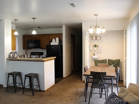 a kitchen and dining room with a table and chairs