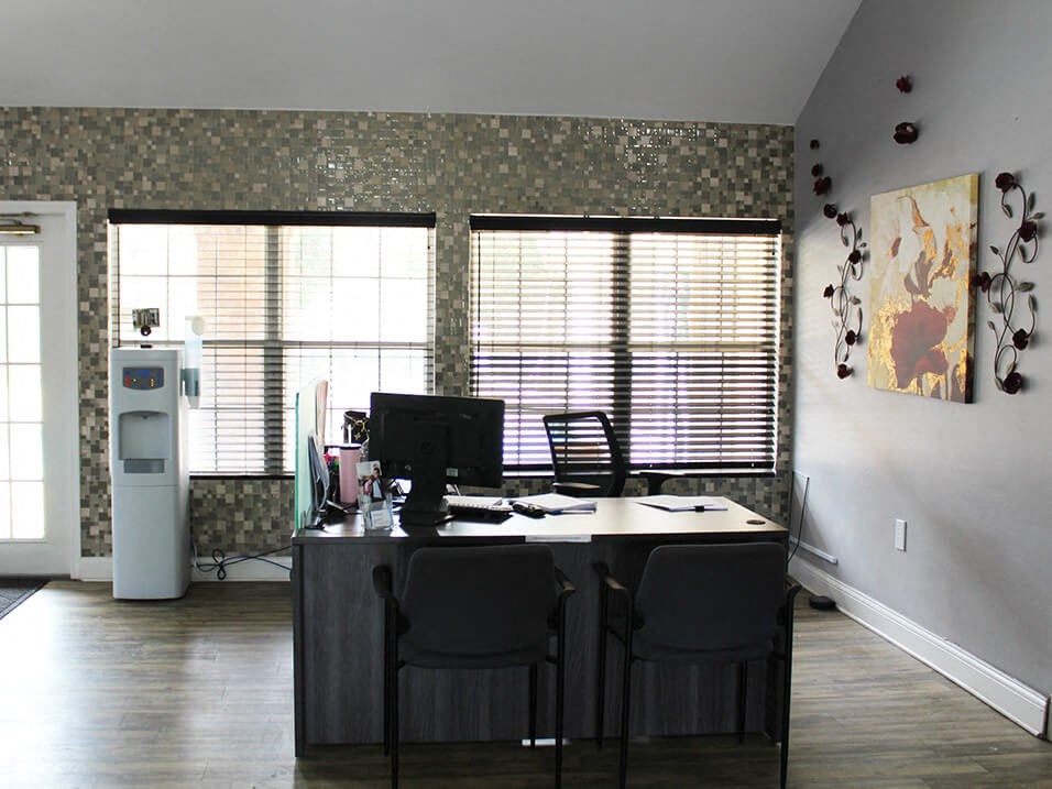 apartment leasing office with a desk and chairs