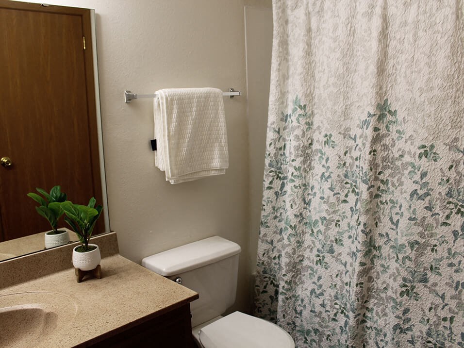 a bathroom with a toilet sink and shower