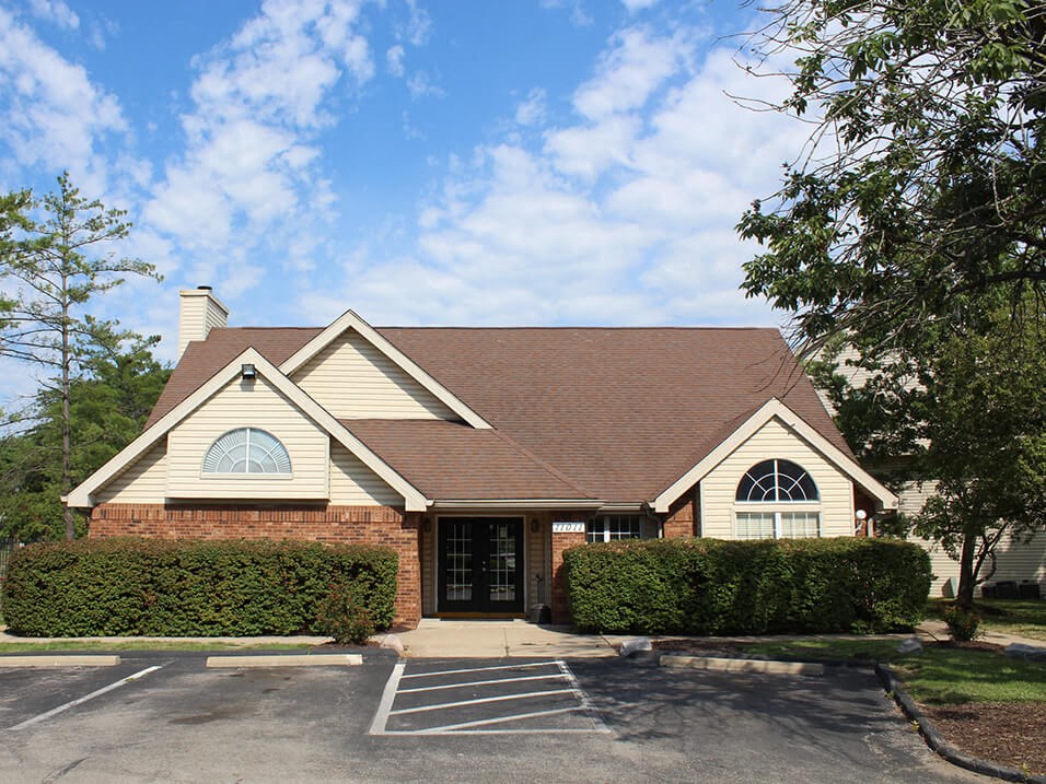 a house with a parking lot in front of it
